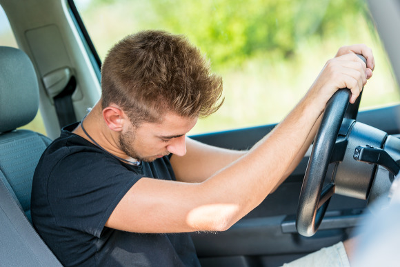 Exhausted driver sleeps in car